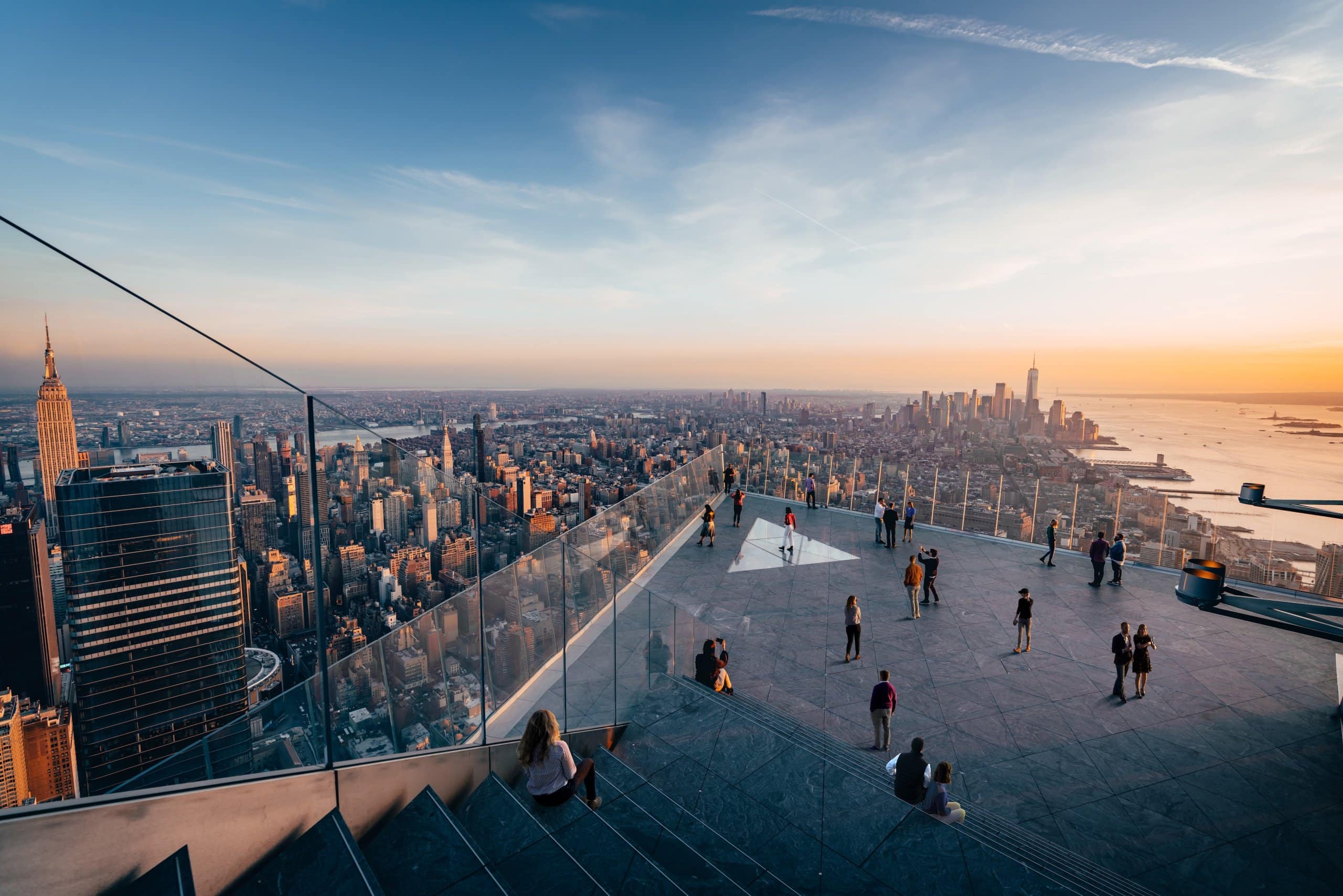 Guests enjoying outdoor sky deck at Edge NYC overlooking the Manhattan skyline.